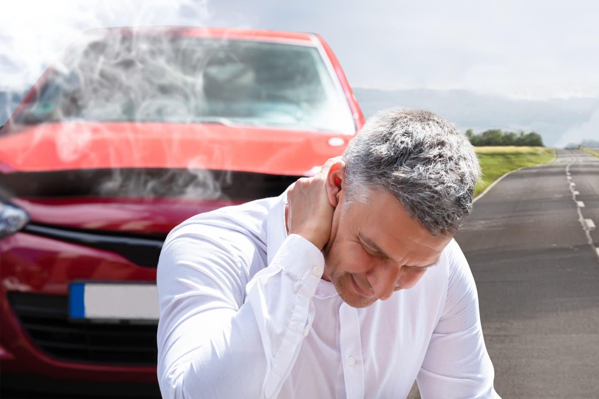 Man holding his neck in pain in front of a damaged red car