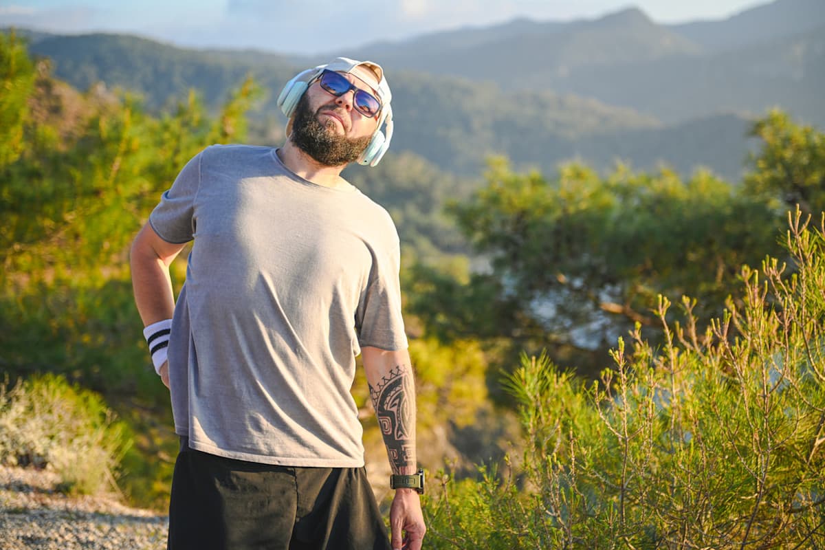 Hiker on a mountain trail holding his lower back